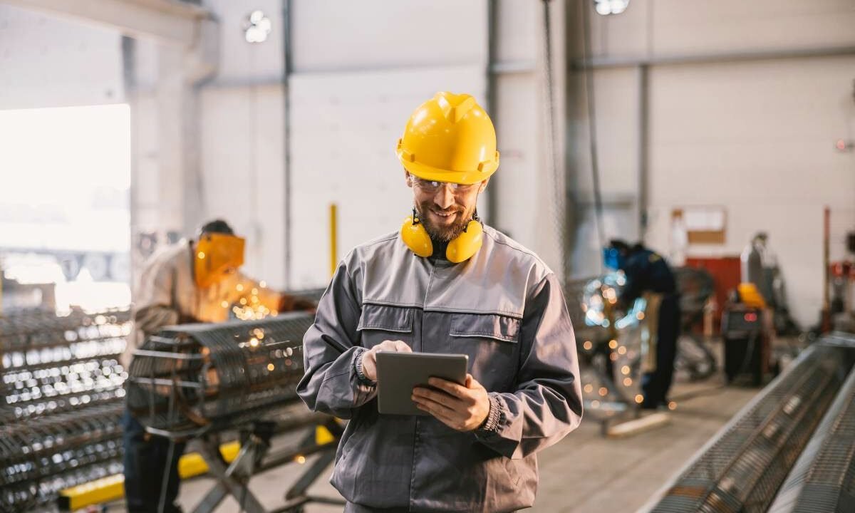 A happy metallurgy supervisor is doing checklist in facility whi