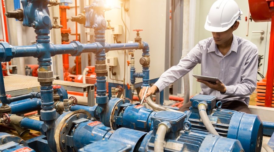 Asian engineer maintenance checking technical data of  system equipment Condenser Water pump and pressure gauge ,  water pump.